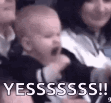Animated gif of a baby celebrating emphatically at a sporting event. The text reads, "YESSSSSSS!!"